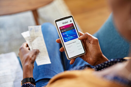 Black woman checking digital wallet on smartphone