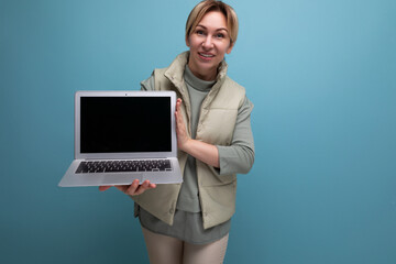 blond millennial woman showing laptop screen with page mockup