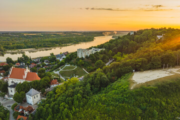 View from the drone in the morning on Kazimierz Dolny. Market square, church and castle ruins.