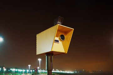 Speed camera takes photos with the flash at night. Speed control at the road.