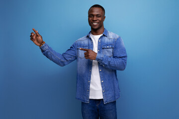 surprised 30 year old handsome american man dressed stylishly shows ea promotional offer with his...