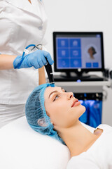 Beauty therapist performing hydrafacial procedure on woman