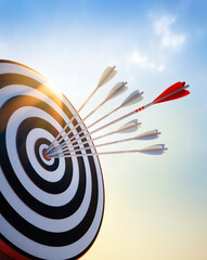 Target board with red and white arrows at sunset - 3D illustration - 628538112