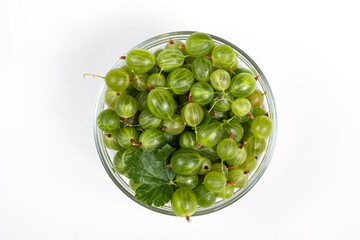 Green ripe gooseberries on a white background top view.