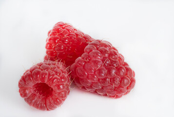 Berries of red ripe raspberries on a white background.