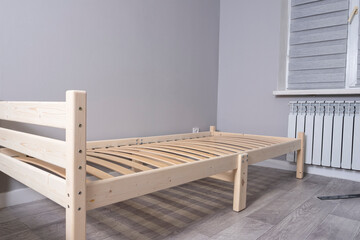 Single wooden bed in the room.