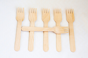 Disposable eco friendly wooden forks on white background. Eco friendly disposable wooden cutlery on white background.