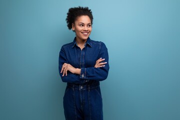 young confident hispanic business woman dressed in blue denim suit over isolated background