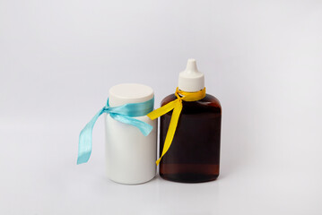 Two vials in the lab. Gift set of skin care products. Two plastic bottles. Gift for a girl on a white background