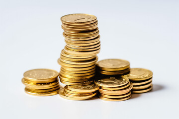 Golden coins rain down on a pristine white floor in a studio setting, reflecting light from powerful studio lights against a clean white background. Alternative AI.