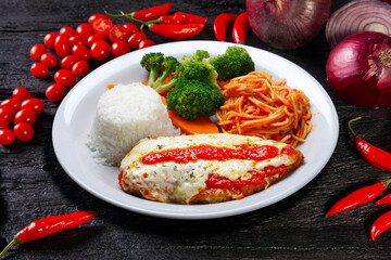 parmigiana steak with pasta, rice and vegetables
