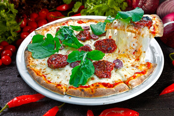 Pizza mozzarella arugula tomato