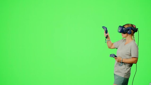 Design artist VR headset drawing picture in virtual reality creativity game. The woman in virtual reality paint imagination picture on chroma key green screen. Concept virtual reality art design game