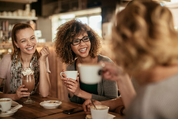 Diverse young group of women enjoying a coffee at a cafe