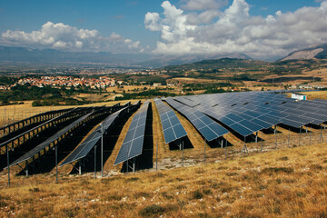 solar panel industry on the yellow  and green mountain fields for environmentally sustainable green energy. The sun allows panels to take energy and create electricity for people in their homes.