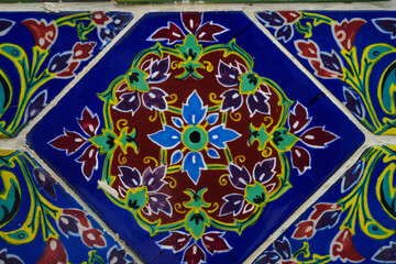 Wat Ratchabophit, Bangkok, Thailand. Completed in 1869. There are many paintings on the tiles using oil paints in various patterns for tourists to see and take pictures. Taken on 25 June 2023.