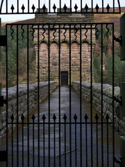 Perfect lines drawn through gate overseeing a water tower