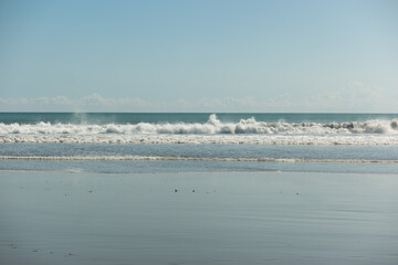 an empty, clear day at the beach with tranquil waves