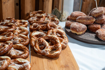 Pretzels and doughnuts on wooden board