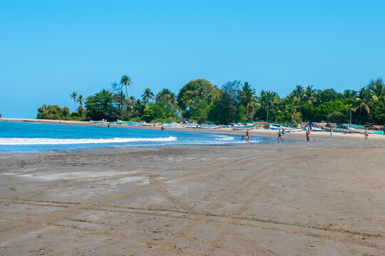 Unidentified people walking on the beach at Calangute beach, Goa, India