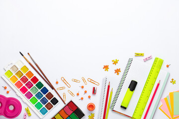 Back to school. Different stationery on white table background, flat lay. Space for text. Top view. Colorful supplies, blank paper, mock up education. Child's creativity. Preschool study, development.