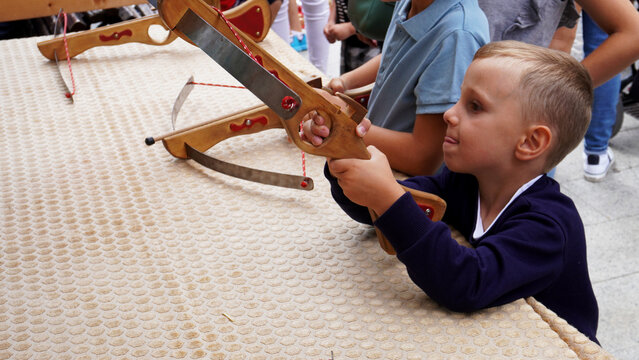 The boy shoots from a crossbow. medieval entertainment at the festival of the middle ages. Estella (Navarre) Spain. June 25, 2023