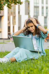 Portrait of lovely preteen child kid use laptop typing browsing working, loses becoming surprised...