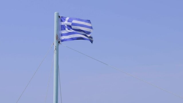 Greek flag waving with blue sky onb background