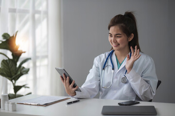 tablet concept connected with online technology communication doctor holding a tablet chatting online. Treat patients via video call.