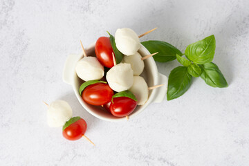 mozzarella, cherry tomatoes and fresh basil - ingredients for caprese salad