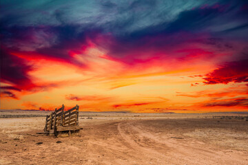 An old corral, abandoned in the desert of Arizona under an evening sky with bright colorful clouds.