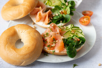 Food, lunch, brunch, meal on a plate, plating concept. Bagels with smoked salmon, cream cheese and capers on a table. Flat lay