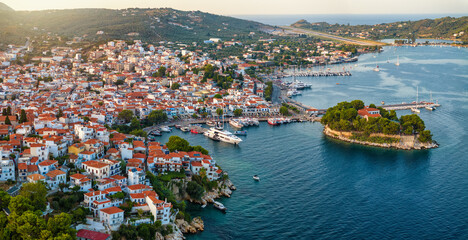 Aerial view of the town of Skiathos island, Sporades, Greece, with Bourtzi peninsula and old harbour during sunset time