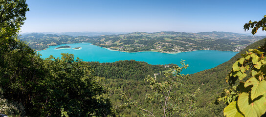 Fototapeta na wymiar Panoramic view of the Lac d'Aiguebelette, a natural lake know for its blue-green colour, located in the commune of Aiguebelette-le-Lac, within the department of Savoie, France. 