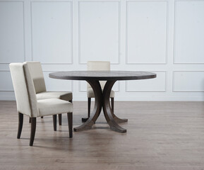 white chairs  and round table. set on wood floor for dinner