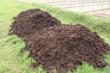 Heap of compost fertilizer on field