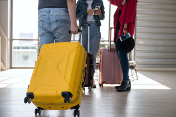 tourist man pull luggage to see his friends at airport departure