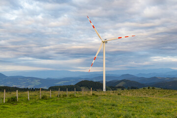 Wind generator on a mountain pasture in the alps in Styria, Austria