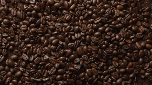 Close up of seeds of coffee top view. Fragrant coffee beans are roasted smoke. 4K ProRes