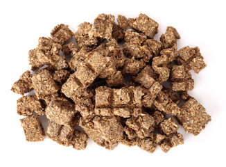 Top view of dried fish pieces for dogs and cats. Snack, treat or reward. Heap of dehydrated flaky fish chunks. Healthy dog snack or health supplement rich on protein, omega 3. Selective focus.