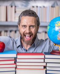 happy teacher with book in library classroom. hispanic teacher in college. Man with books in library. Knowledge and education. school library. Teachers day. Teacher in school classroom