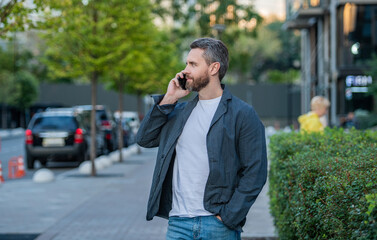man having mobile call in the street. man call on mobile outside. photo of man call