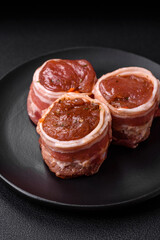 Delicious raw fresh pork or chicken meat rolls wrapped in bacon