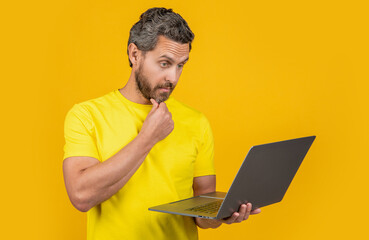 shocked man freelancer in studio. photo of man freelancer with laptop. man freelancer