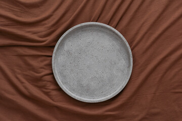 Empty black plate over dark stone background with free space. Top view, flat lay