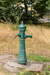 Fototapeta na wymiar an old water pump in nature