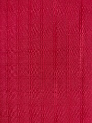 a red fabric with square grid pattern