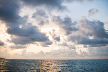 a sunset through clouds over the Pacific Ocean