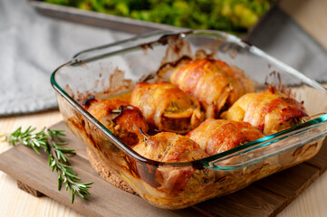 Baked honey-mustard chicken thighs with rosemary and wrapped in bacon
