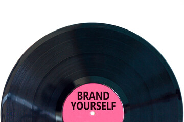 Brand yourself symbol. Concept words Brand yourself on beautiful black purple vynil disk. Beautiful...